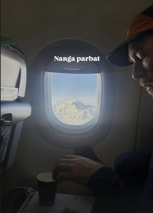 Seba Pelleti in a plane, with Nanga Parbat seen from the plane's window