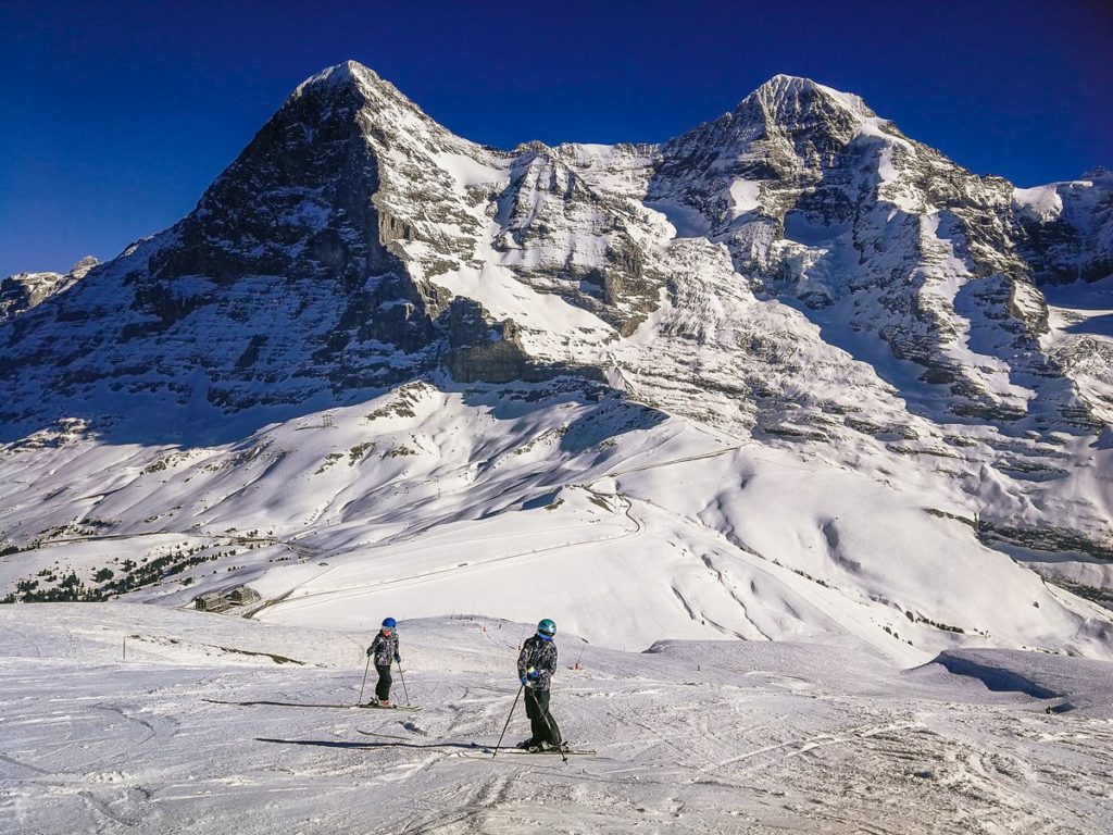 Skiers on slopes with Eiger in Background, Swill Alps.