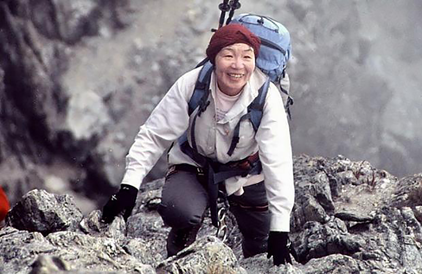 Japanese woman climber on rocky mountain