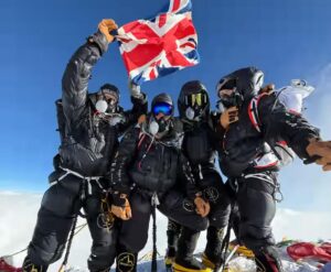 Brit climbers on O2 wave a Union Jack on the summmit of Everest.