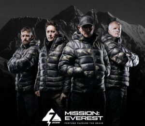 Studio photo of four Everest climbers in black feather jackets