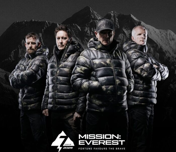 Studio photo of four Everest climbers in black feather jackets
