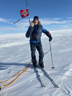 Polar explorer Borge Ousland holding his ski pole aloft