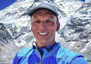 Close shot of Karl Egloff with Everest behind him.