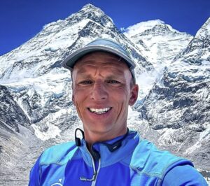Close shot of Karl Egloff with Everest behind him.