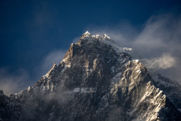 Summit ridge of lhotse with some clouds wrapping its rocky spires