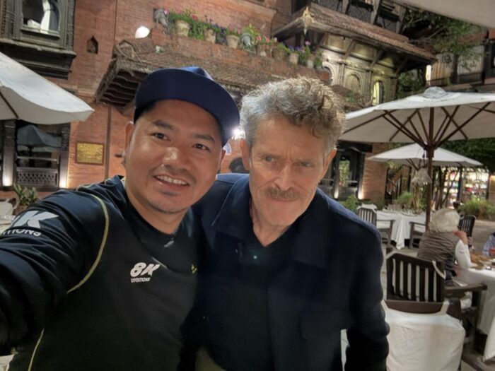 Pemba and Dafoe at night by a terrace-bar in Kathmandu