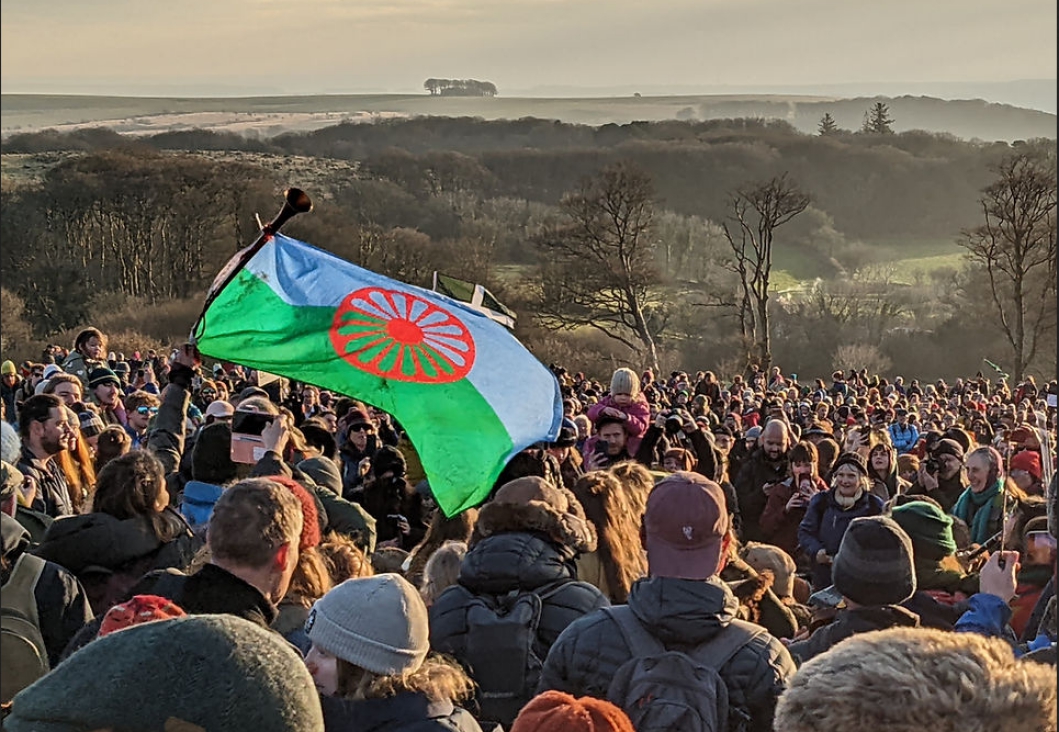 A crowd on the moor waving flags and signs