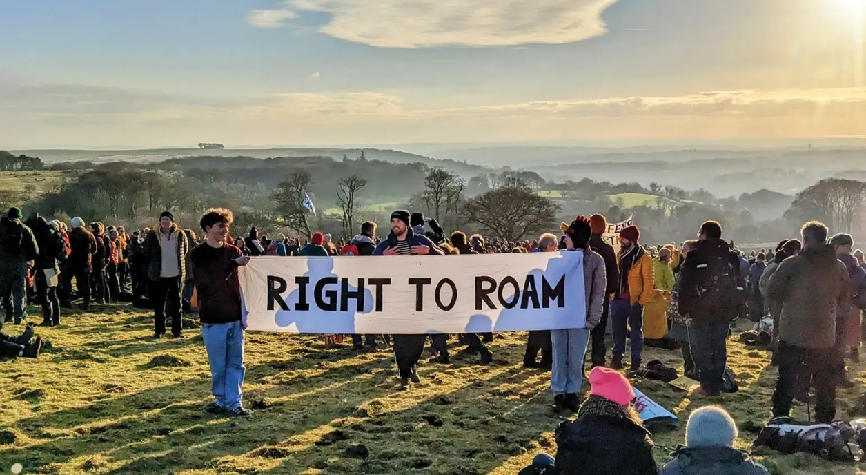 A crowd with signs on the moor