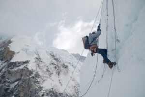A climber jumaring on a vertical serac on Everest.