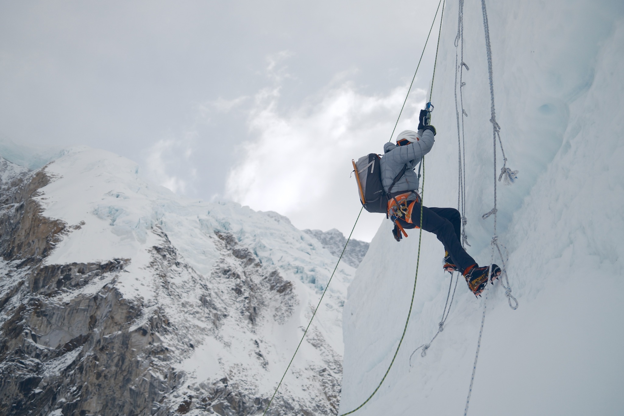 A climber jumaring on a vertical serac on Everest.