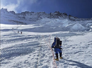 Climbers on fixed ropes heading up on the steep snow ramp of the Lhotse face, towards Everest's Camps 3 and 4