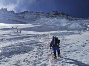 Climbers on fixed ropes heading up on the steep snow ramp of the Lhotse face, towards Everest's Camps 3 and 4