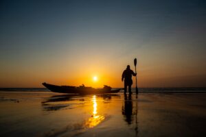 silhouette of kayaker at sunset