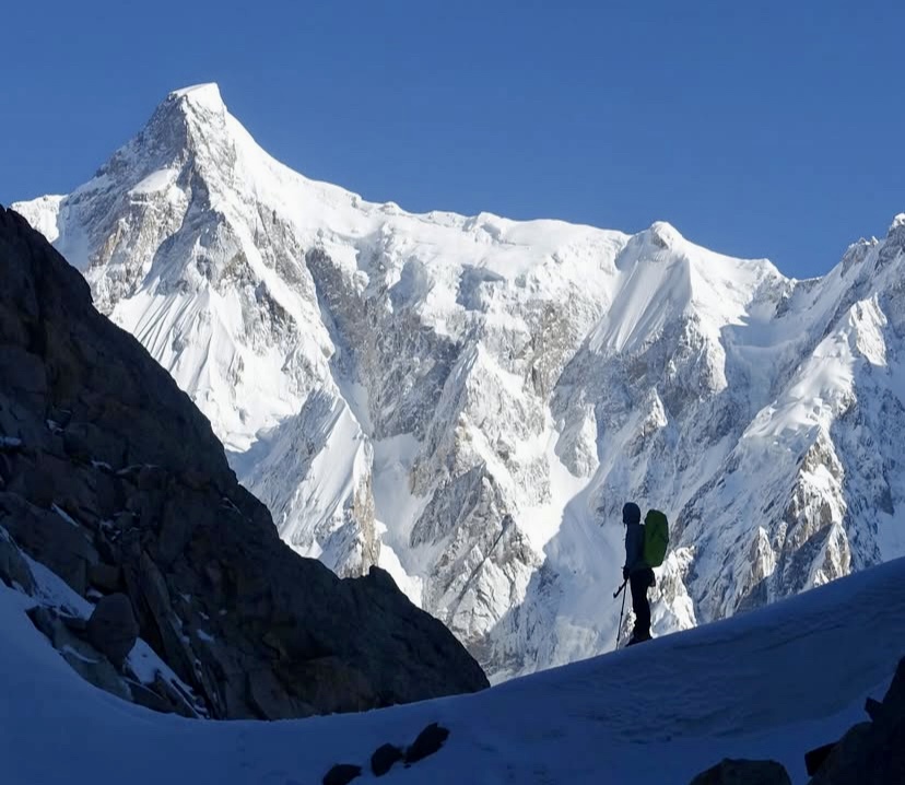 One of the climbers watching the Southeast Pillar of Ultar Sar.