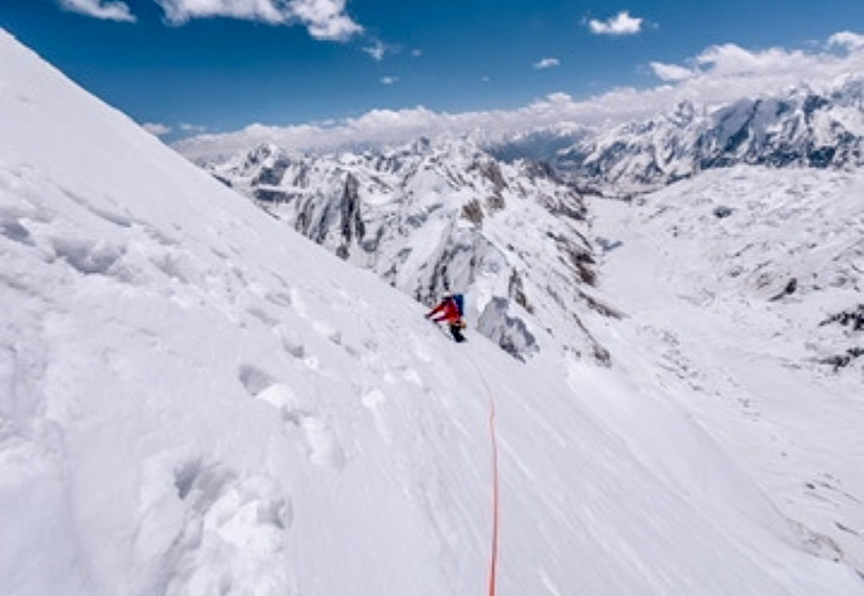 small climber on snow slope