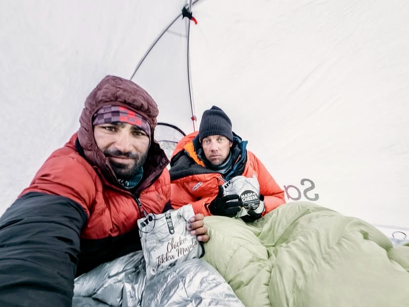 Mueez Ud Din (left) and Mathieu Maynadier eating Tikka Masala chicken, and cheese at one of their bivy sites.