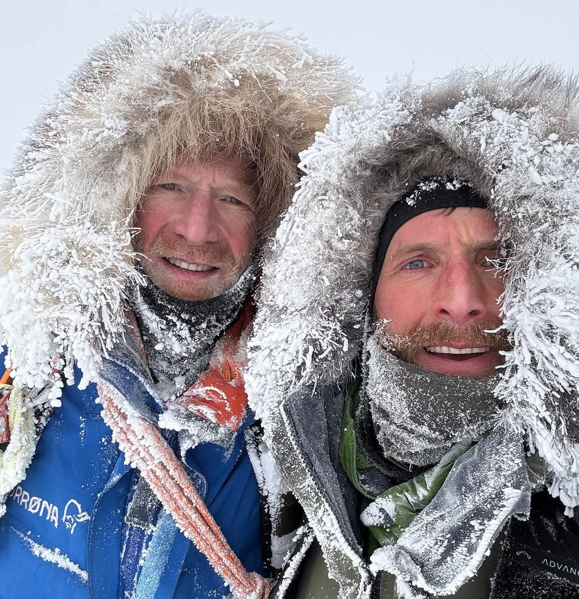 portrait of two snowy travelers