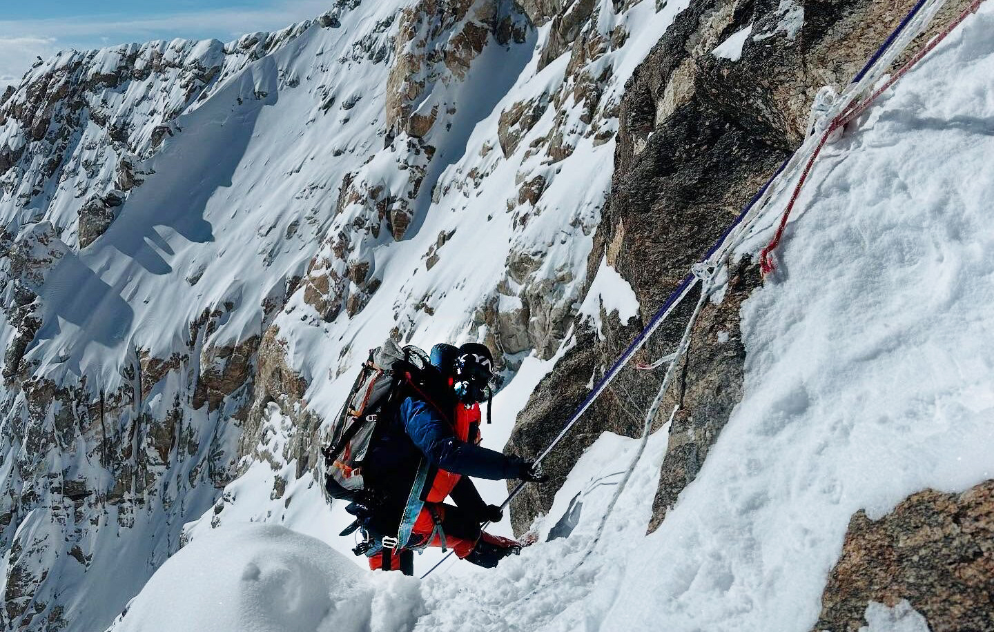 A climber approaches the summit ridge of Kangchenjunga, clipped to the fixed ropes.