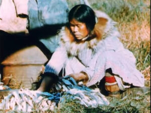 Alaskan native woman sitting, working