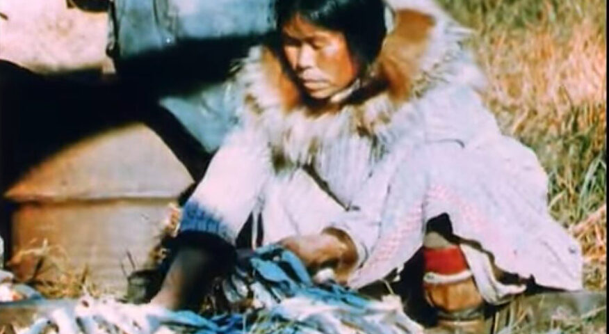 Alaskan native woman sitting, working