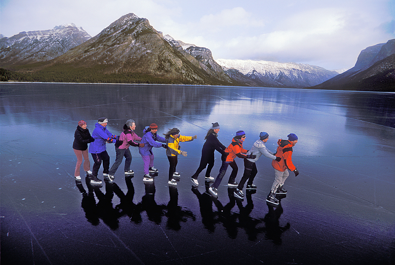 line of skaters on frozen lake