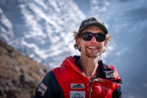 Close shot of tyler Andrews with sunglasses and baseball cap.