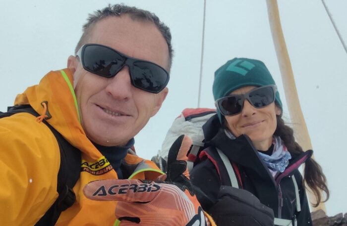 Denis Urubko and Maria Cardell inside a tent with sunglasses on.