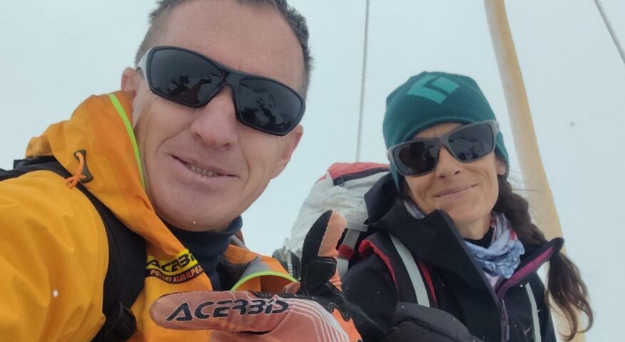 Denis Urubko and Maria Cardell inside a tent with sunglasses on.