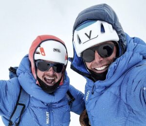 Close shot of climbers in a summit in a cloudy day.
