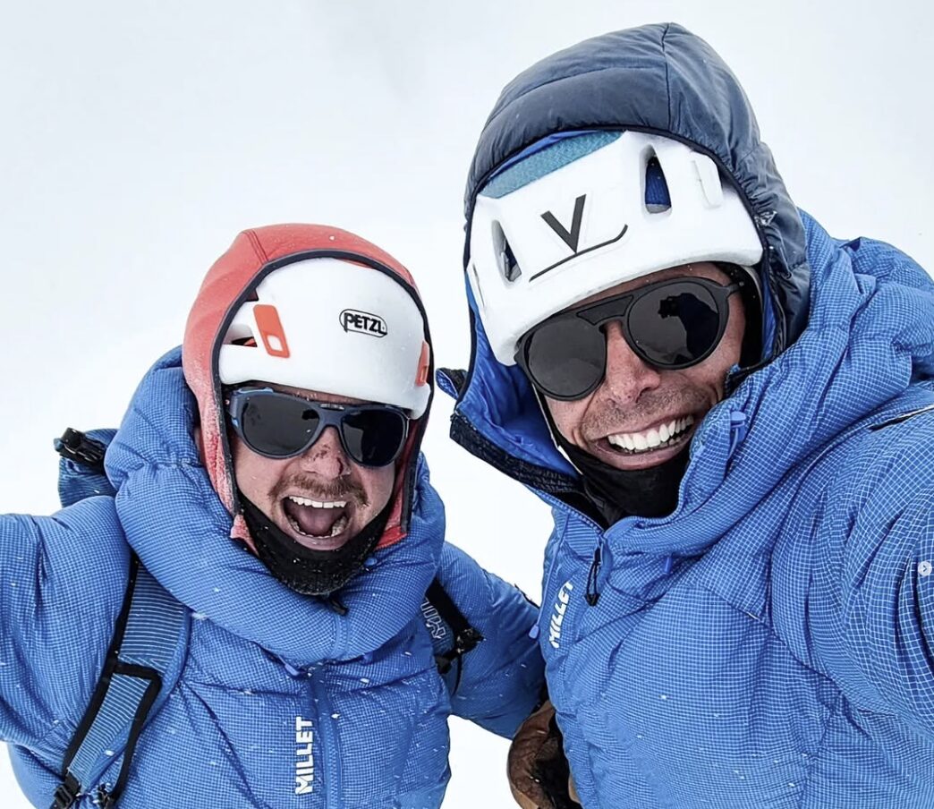 Close shot of climbers in a summit in a cloudy day.