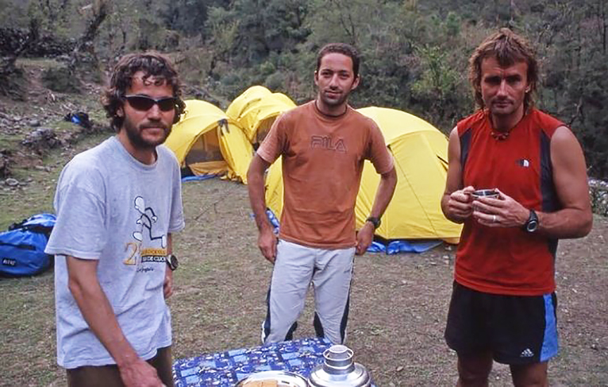 three young climbers by their tents