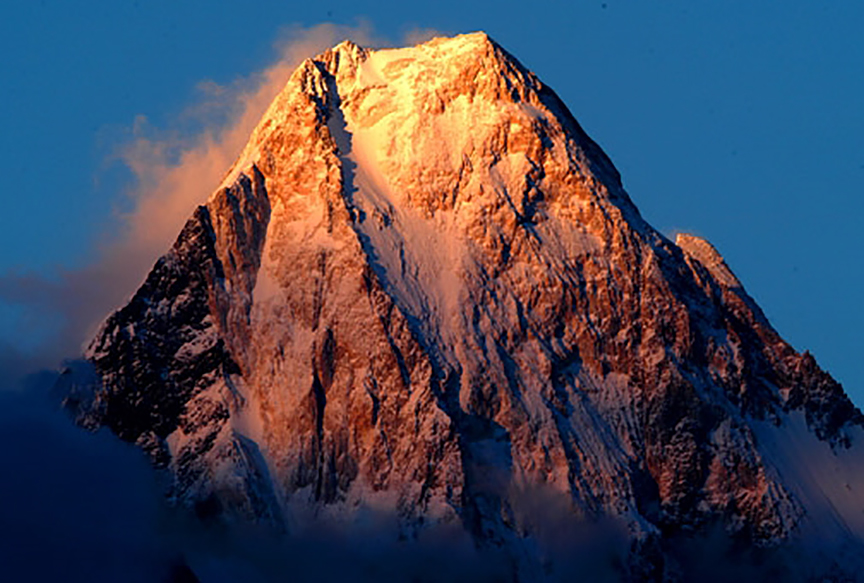 top of mountain lit by alpenglow