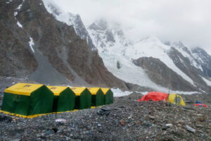 tents against a dark grey mountain background