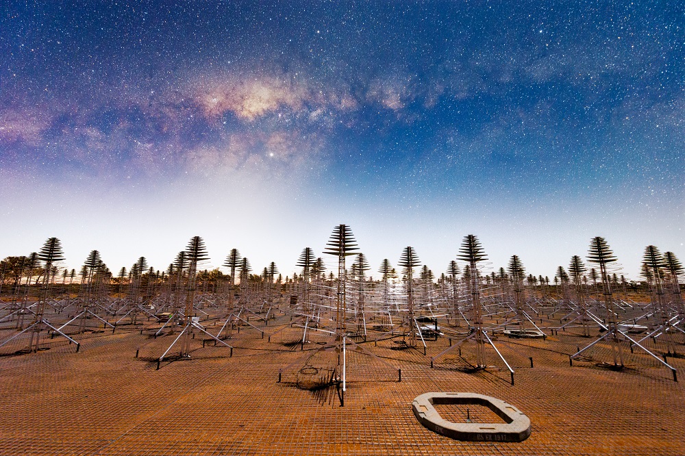 A group of metal antenna in a desert.