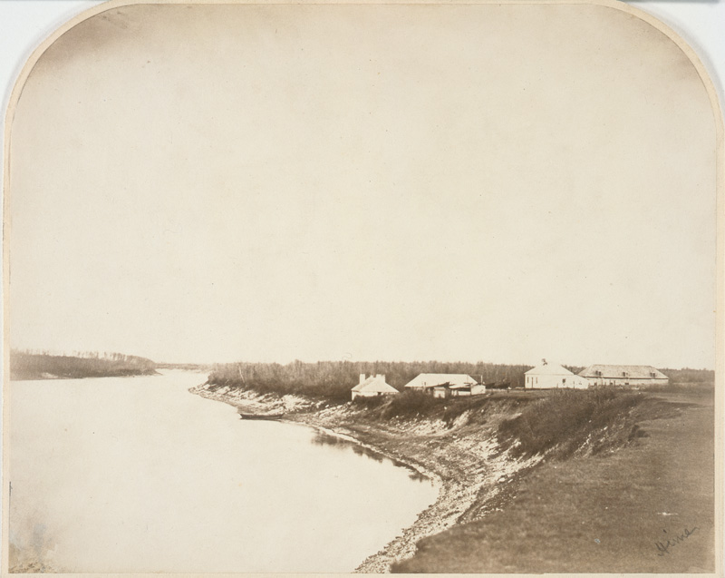 A collection of buildings beside a river