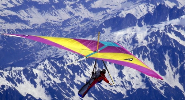 Jean-Marc Boivin hang gliding among giant peaks.