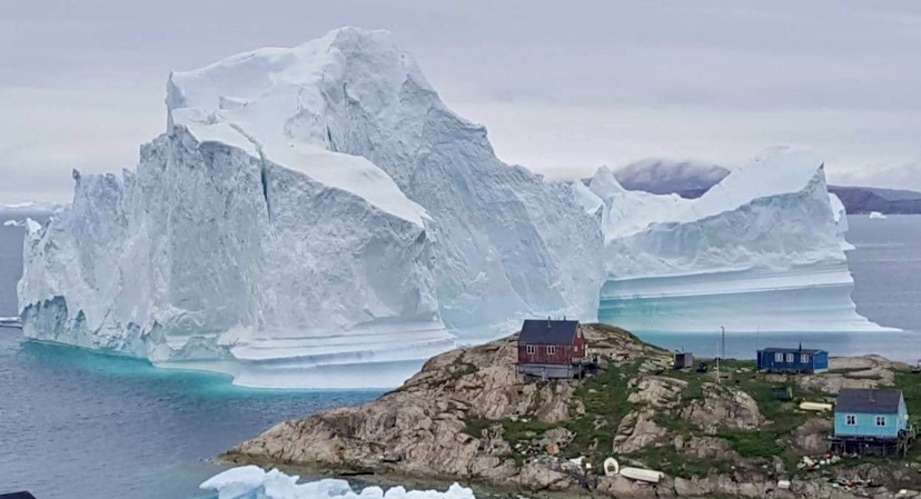 Massive iceberg very close to Innaarsuit's houses.