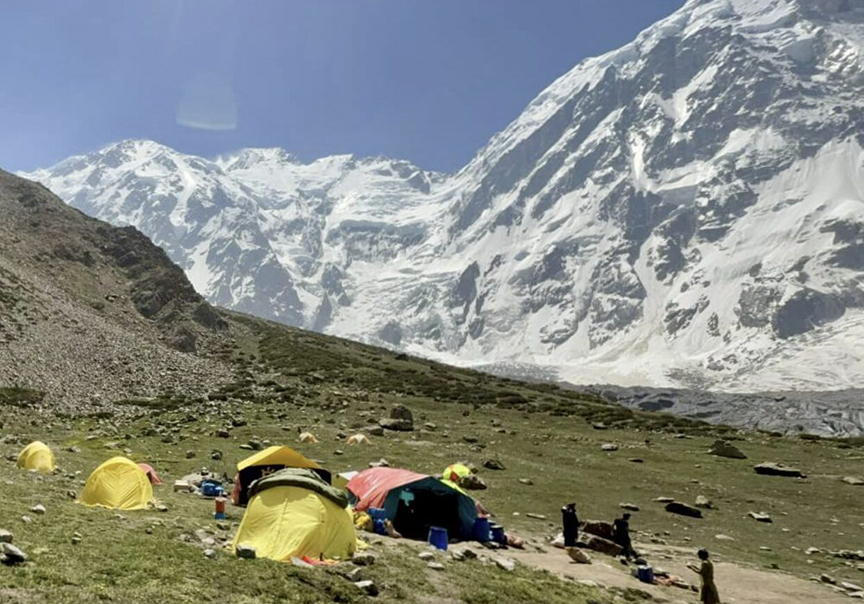 view of a green base amp at the foot of white Nanga Parbat