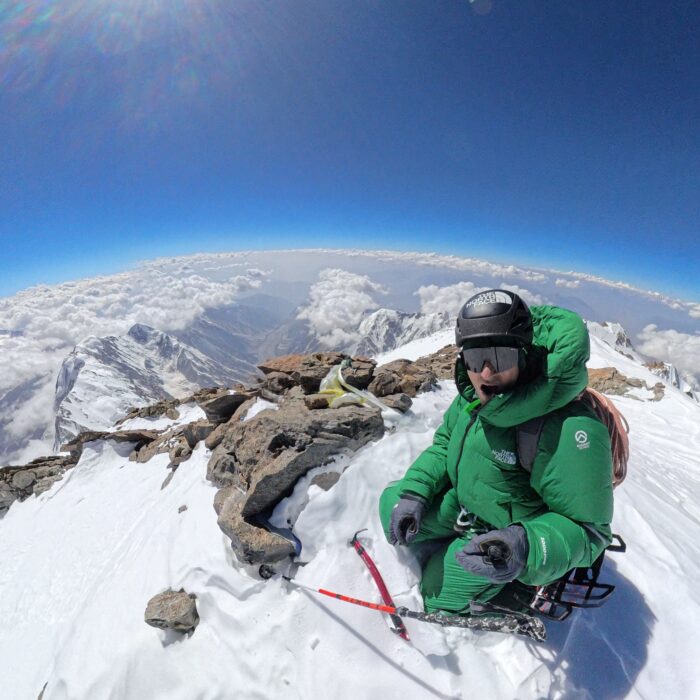 Gooettler takes a selfie of himsel on the snow and rocks of Nanga Parbat's summit.