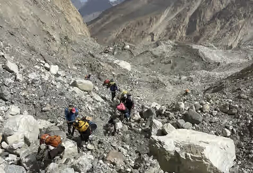 Porters with mules traverse a very rough moraine in Shimshal.