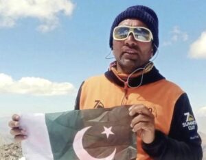 Close shot of Pakistani climber Iftikhar Hussain holding his national flag.
