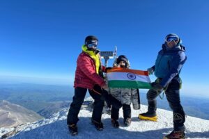 A little kid in a big jacket on the summit of Elbrus