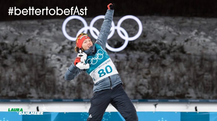 Dahlmeier raise her arm in triumph from the top of an Olympic podium. 