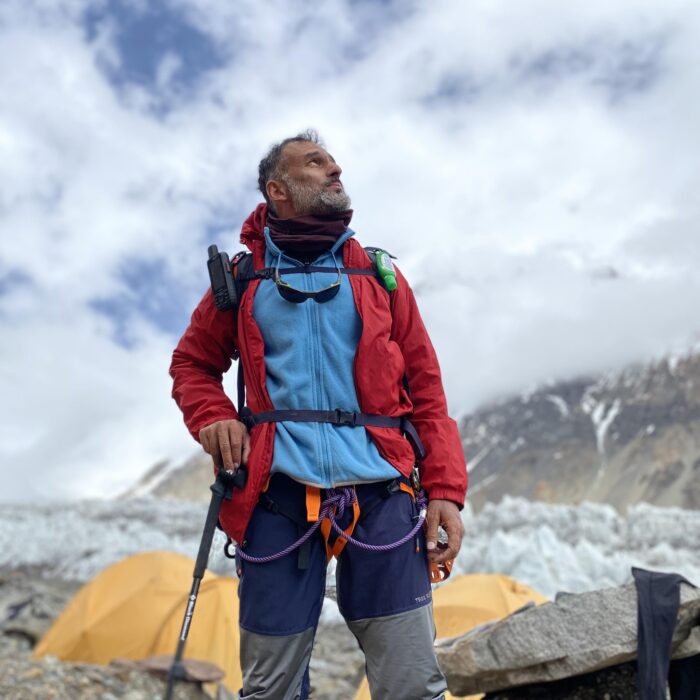Dr Hassan at a Base Camp, looking up.