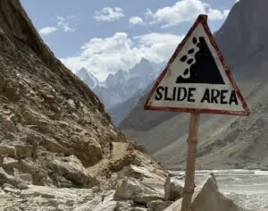 A sign noting danger of rock slides on a trail in the Karakoram.