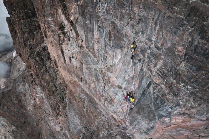 Climbers on a large rock face.