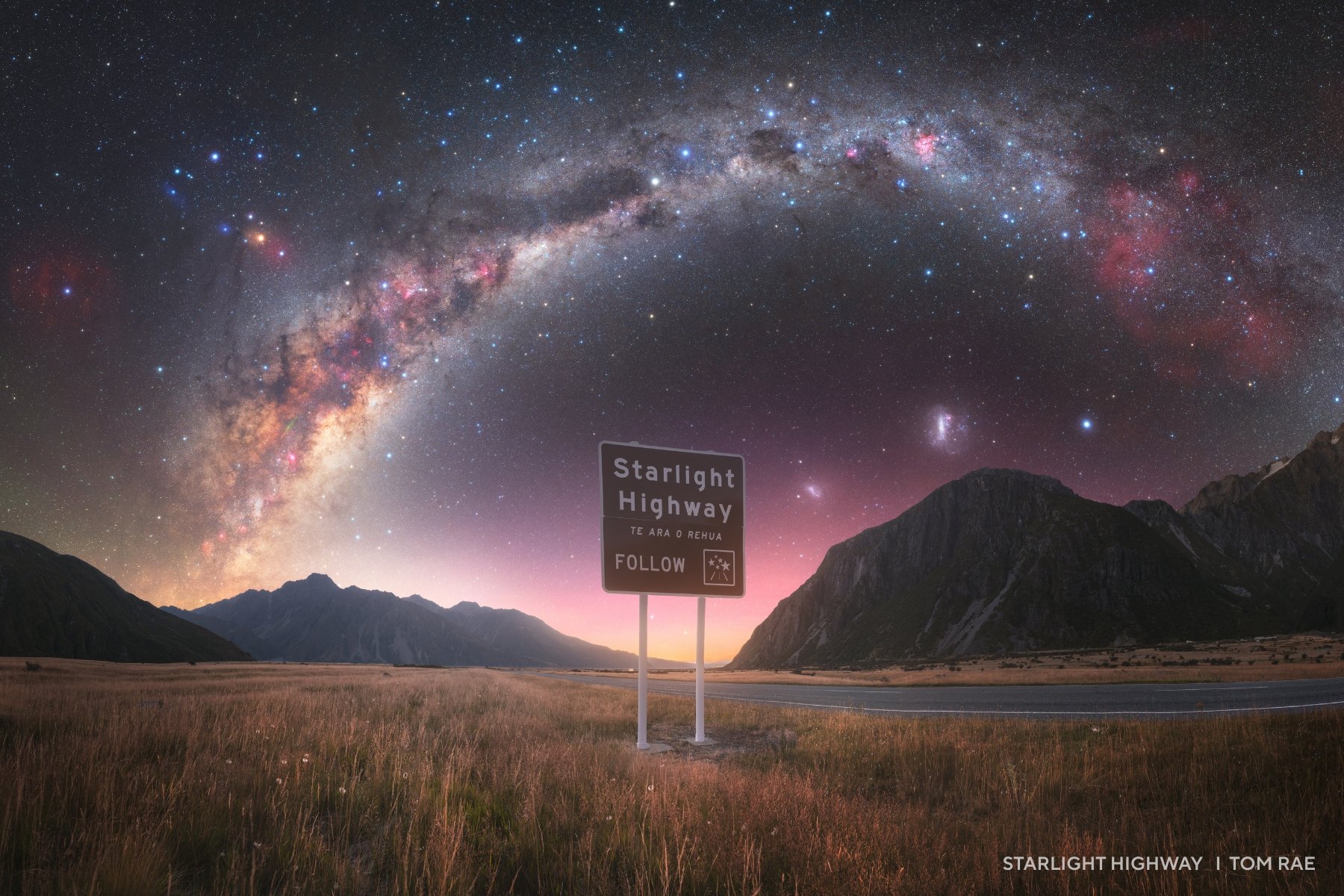 A sign reading "starlight highway" beneath the Milky Way. 