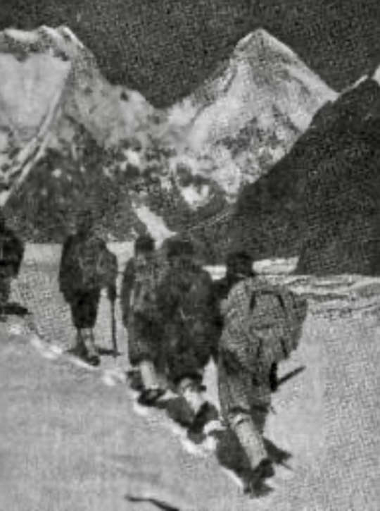 Climbers on the Zvyozdochka Glacier during one of the early expeditions to the region. In the background Chapaev Peak and Khan Tengri.