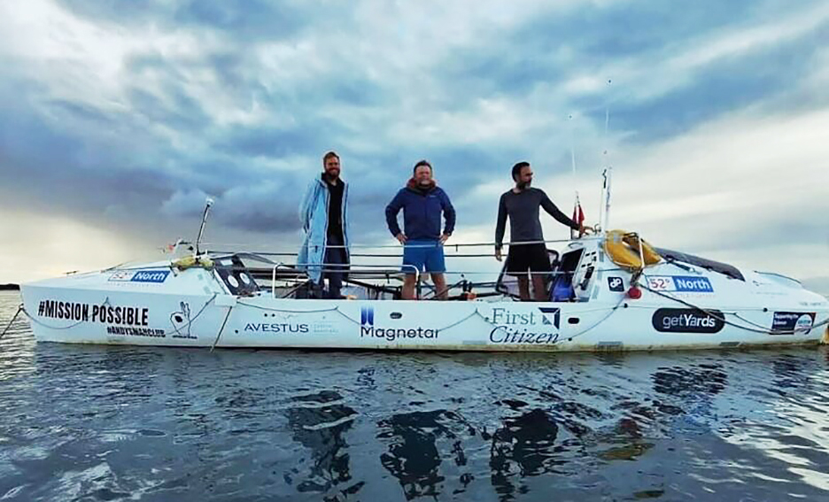 rowers pose at sea